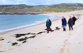 Guests walking on Taransay beach