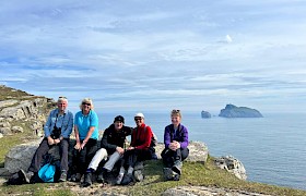 Guests at the top of Conachair, St Kilda by Guide Lynsey Bland